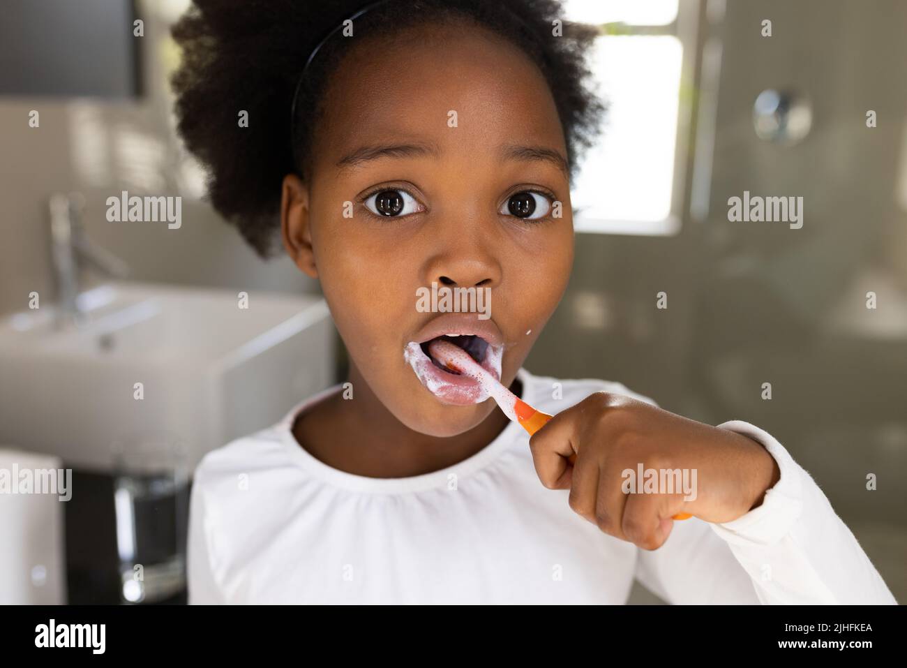 Image of african american girl brushing teeth Stock Photo