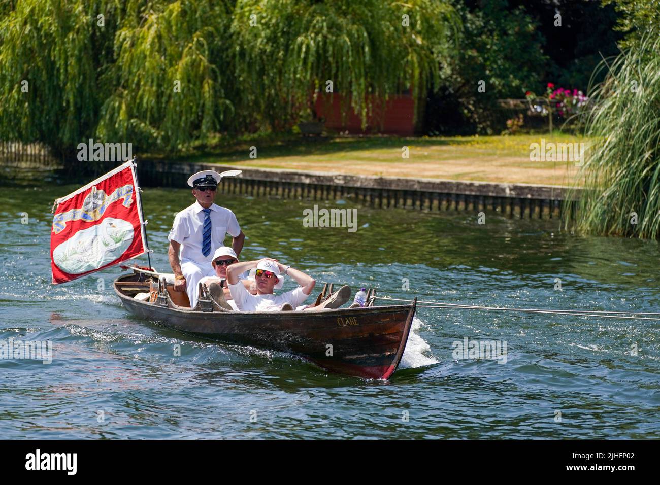 Swan Uppers rowing near Staines-upon-Thames in Surrey, during the ancient tradition of Swan Upping, the annual census of the swan population on the River Thames. Picture date: Monday July 18, 2022. Stock Photo
