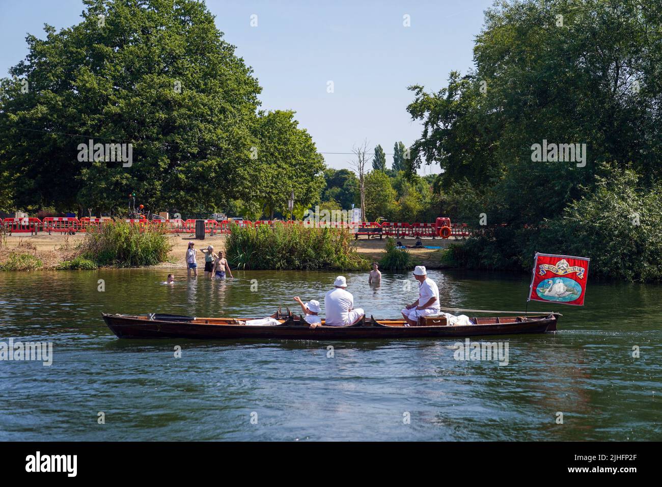 Swan Uppers rowing near Chertsey in Surrey, during the ancient tradition of Swan Upping, the annual census of the swan population on the River Thames. Picture date: Monday July 18, 2022. Stock Photo