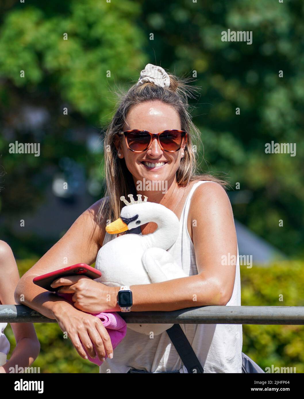 A lady holds a toy swan as Swan Uppers rowing near Sunbury Lock Cut in Middlesex, during the ancient tradition of Swan Upping, the annual census of the swan population on the River Thames. Picture date: Monday July 18, 2022. Stock Photo