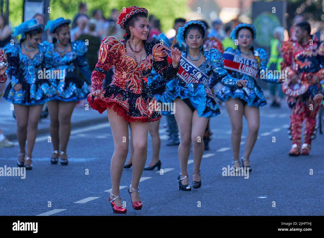 Caporales dancers in ornate costumes performing at the annual carnival as it progresses through the streets of the historic city of Bath in Somerset. Stock Photo
