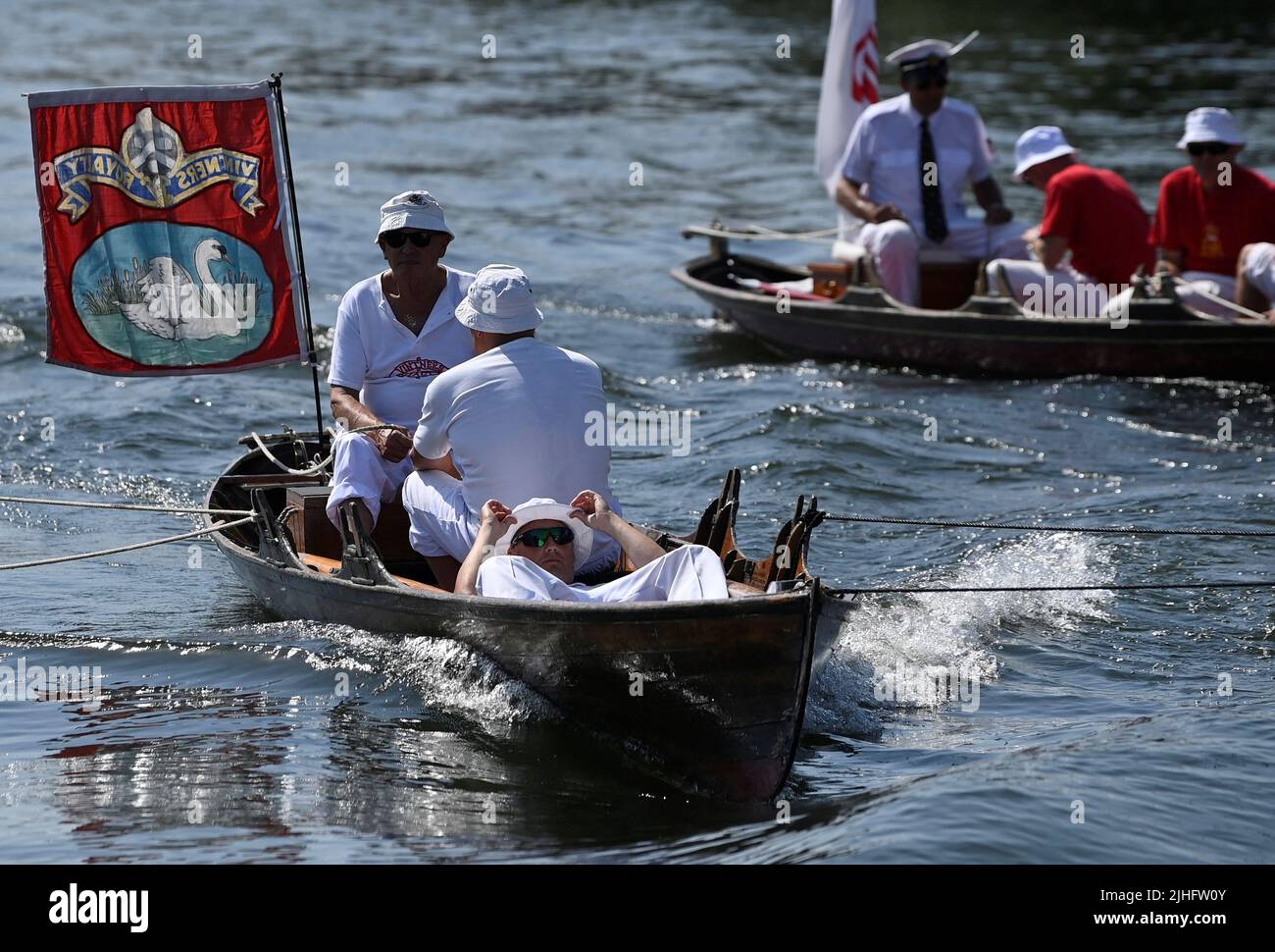 Swan Uppers are towed during the annual census of the swan population along sections of the River Thames, Shepperton near Windsor, Britain, July 18, 2022. REUTERS/Toby Melville Stock Photo