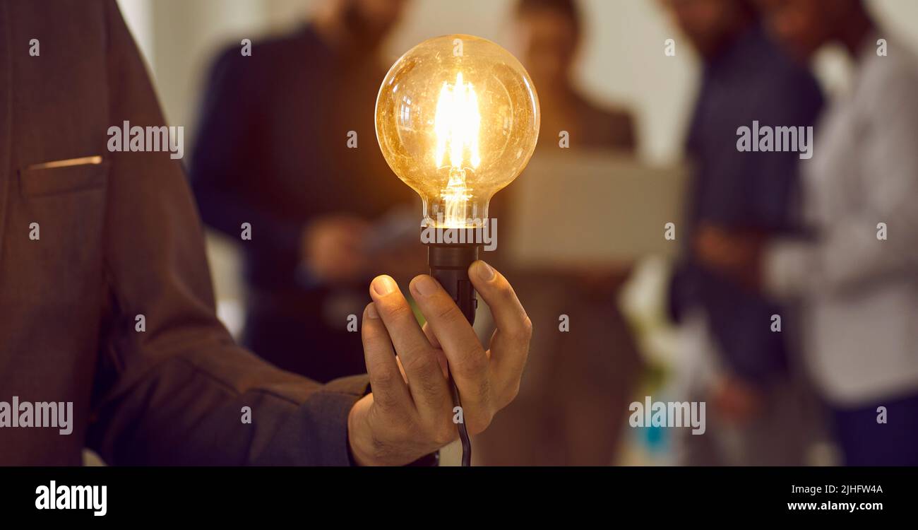 Businessman holding light bulb as concept of creative idea, business ...