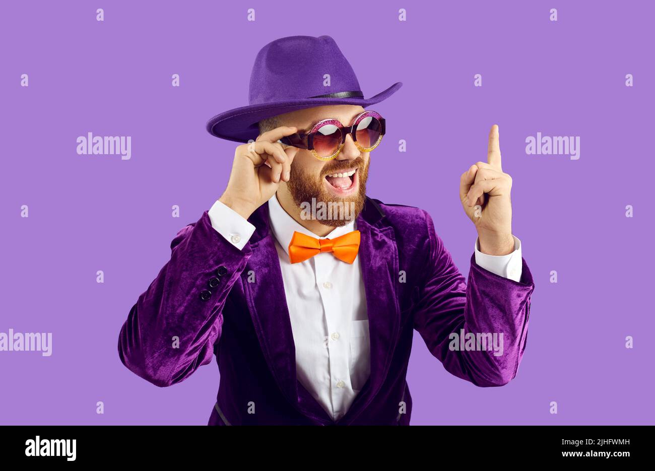 Smiling male performer in suit point at deal offer Stock Photo