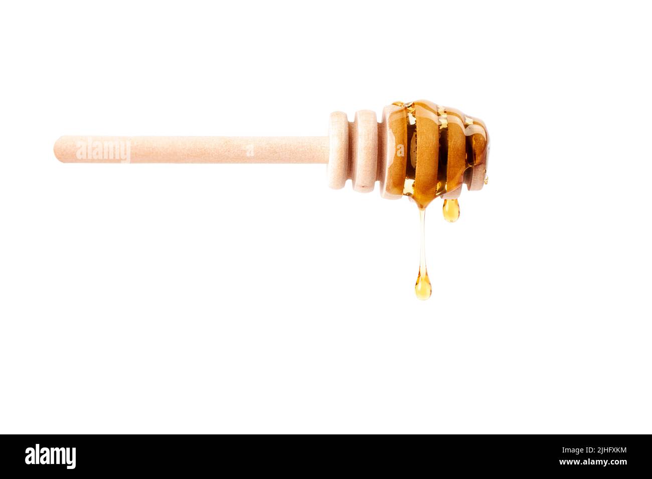 Honey dripping from a wooden dipper on white background. Sweet bee product for your design with copy space Stock Photo