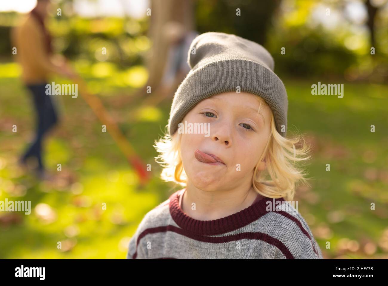 Image of happy caucasian boy making funny faces in garden Stock Photo