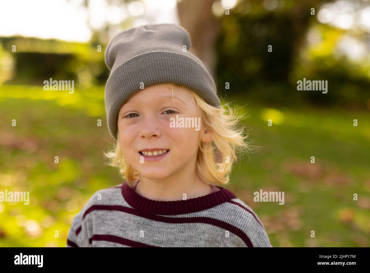 Image of happy caucasian boy smiling at camera in garden Stock Photo