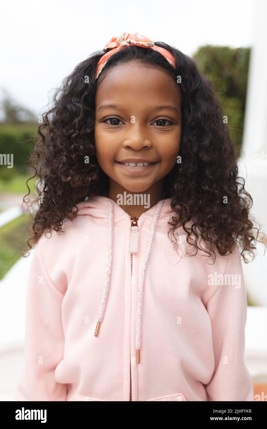 Vertical image of happy african american girl posing at camera Stock Photo