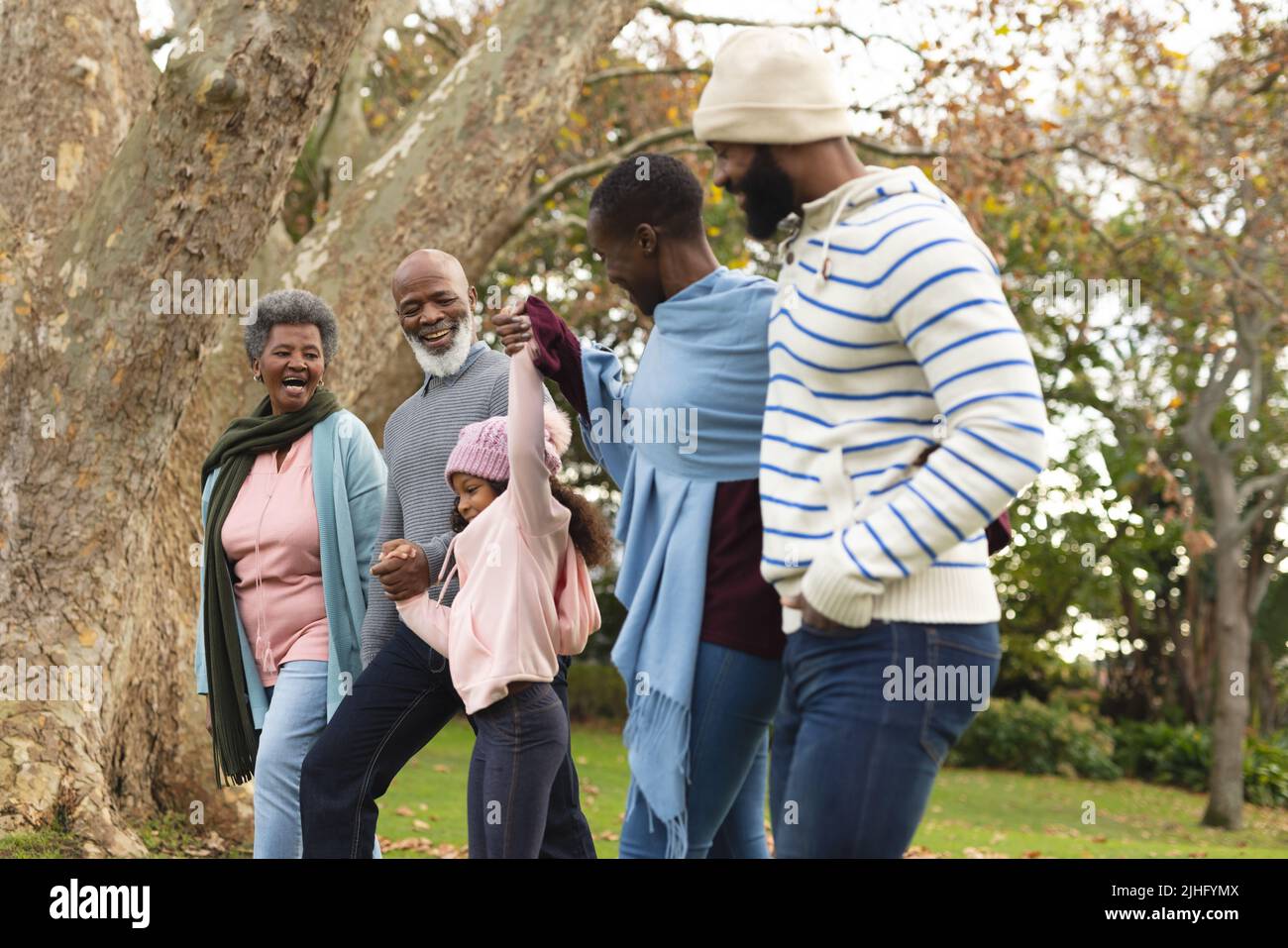 Image of happy multi generation african american family having fun outdoors in autumn Stock Photo