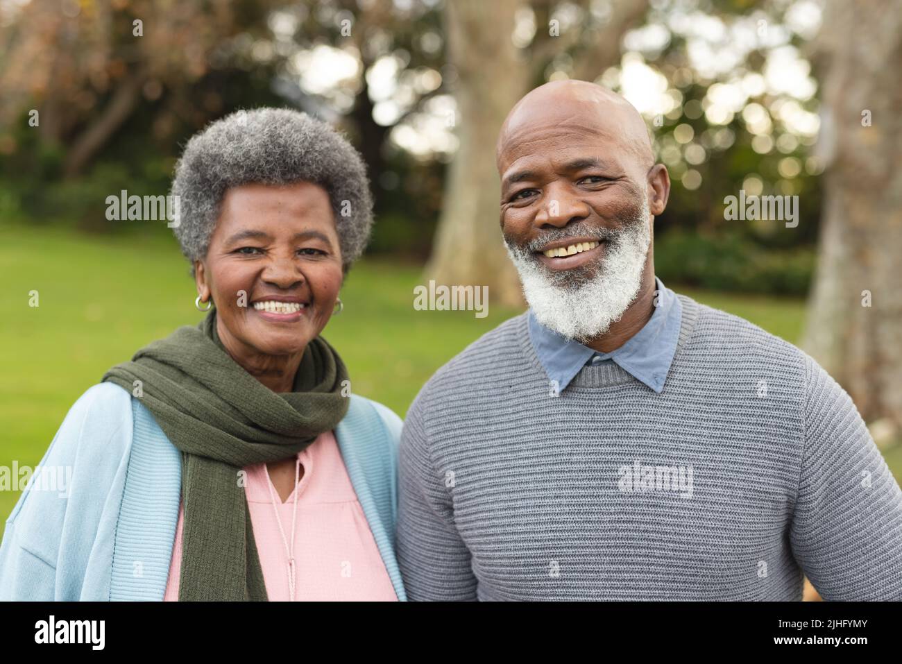 Image of happy african american senior couple posing at camera outdoors ...