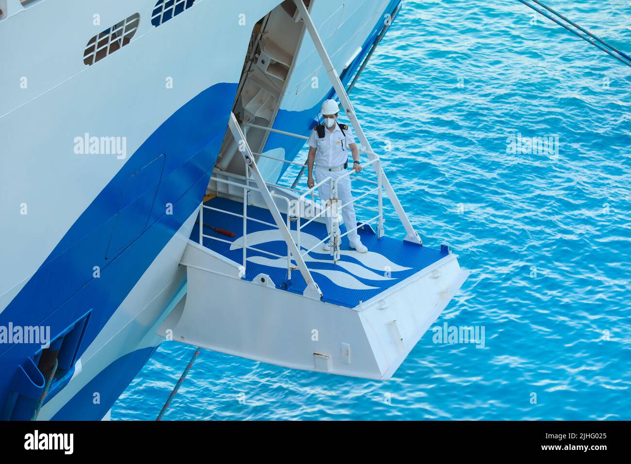 Ship's officer standing on the mooring plaform to oversee the safety of