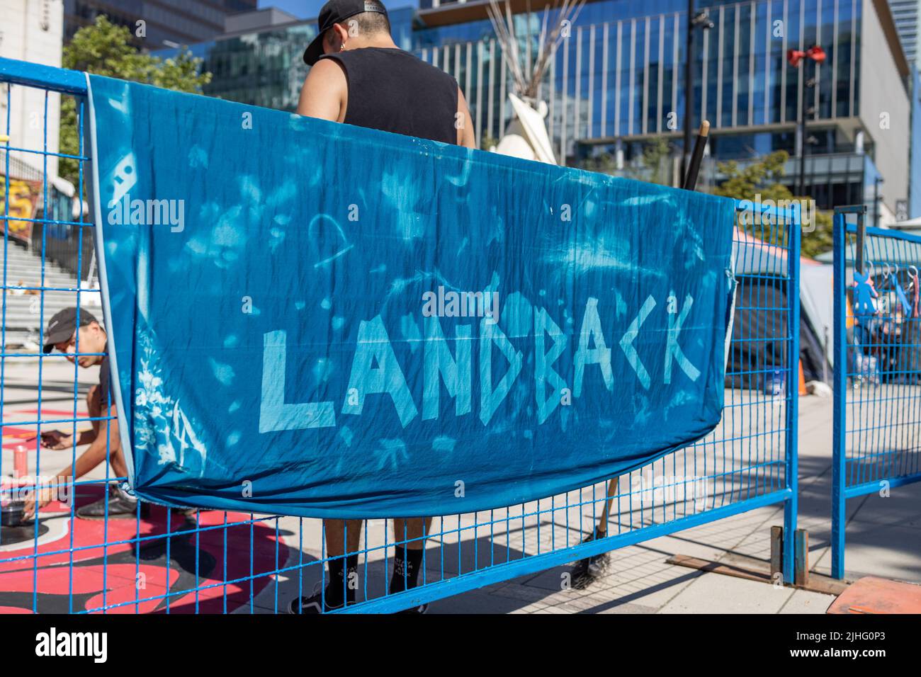 Vancouver, Canada - July 1,2022: View of sign Land Back as part of protest against celebration of Canada day in front of Vancouver Art Gallery Stock Photo