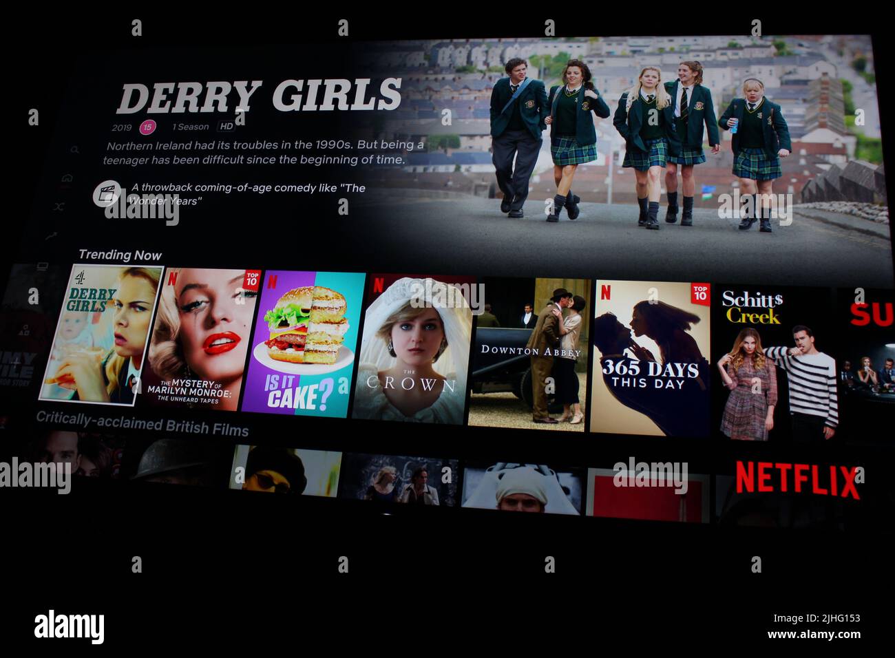 London, UK - May 1, 2022: Netflix app on tv screen showing Derry Girls. Netflix has recently been losing subscribers as people tighten their budgets Stock Photo
