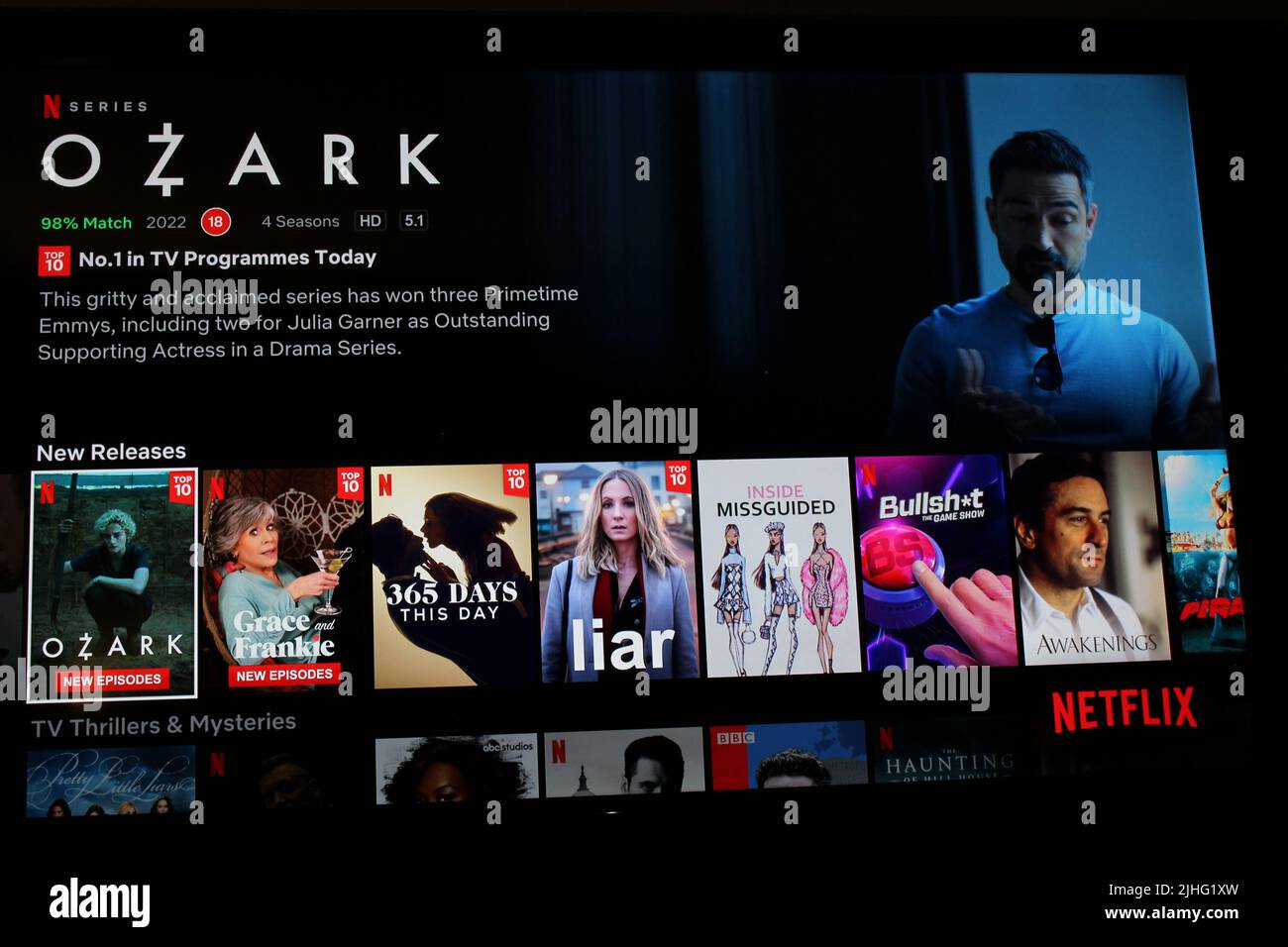 London, UK - May 1, 2022: Netflix app on tv screen showing the TV show Ozark. Netflix has recently been losing subscribers as people cut costs Stock Photo