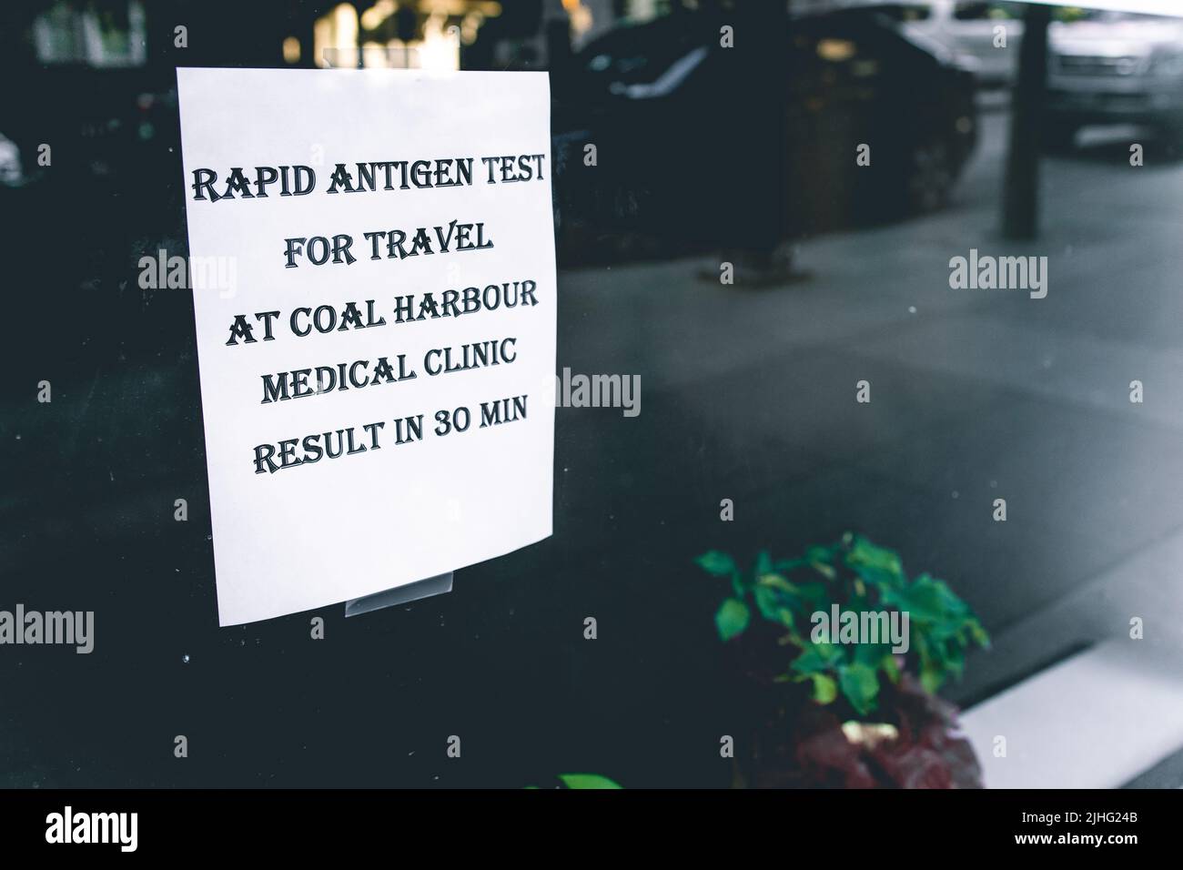 Vancouver, Canada - July 1 , 2022: View of sign Get Rapid Tested for Covid-19 on the door at Coal Harbour Medical Clinic Stock Photo