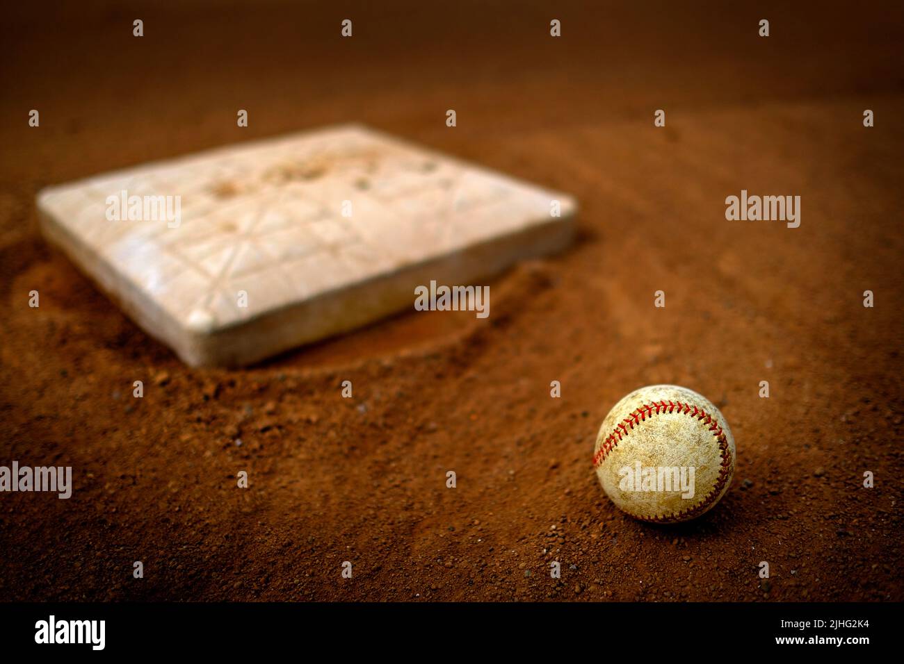 Old leather baseball on dirt field by home plate or a base Stock Photo ...