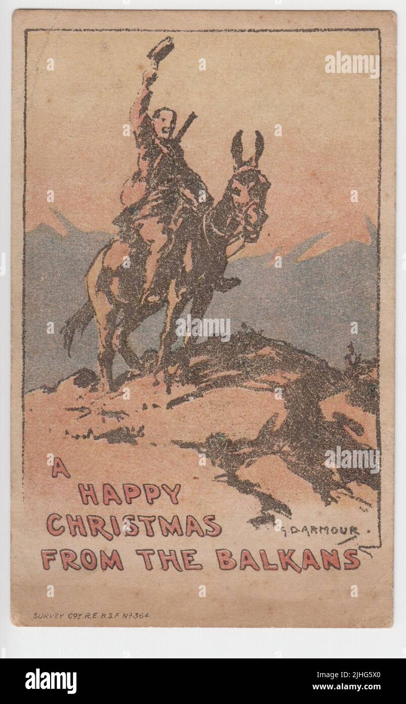 'A Happy Christmas from the Balkans': First World War Christmas card produced for Survey Company, Royal Engineers, British Salonika Force (BSF). It shows a soldier raising his cap whilst sitting on a donkey or ass Stock Photo