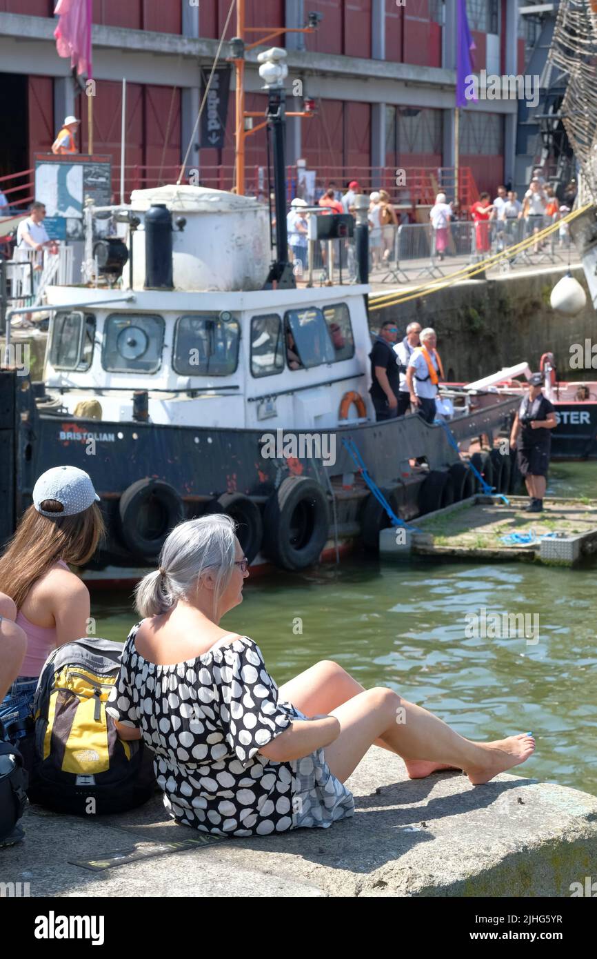 Woman sitting at on the quay side at the Bristol Harbour Festival Bristol UK Stock Photo