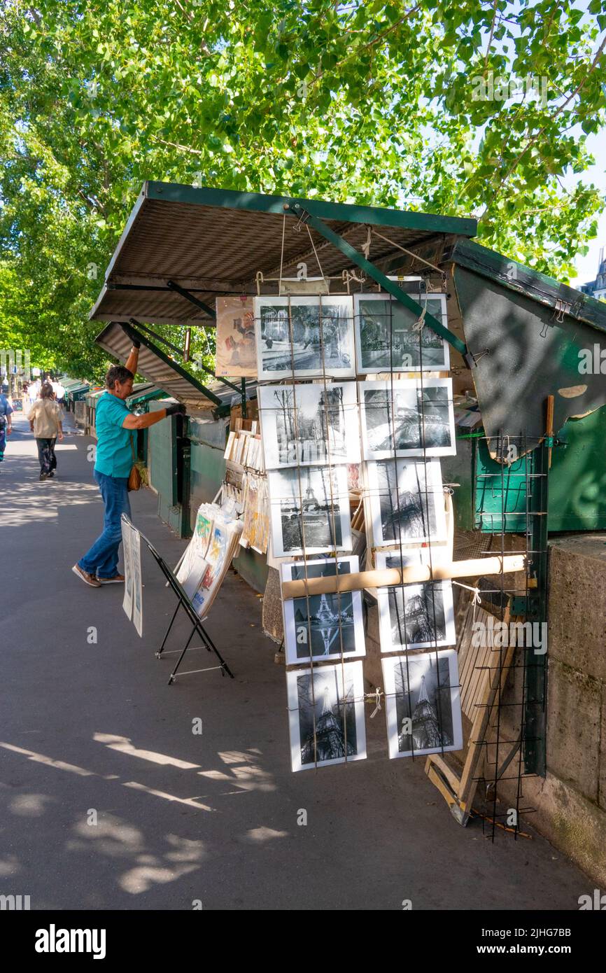 Les bouquinistes being opened for trading the famous iconic riverside shopping kiosks along the river Seine in Paris Stock Photo