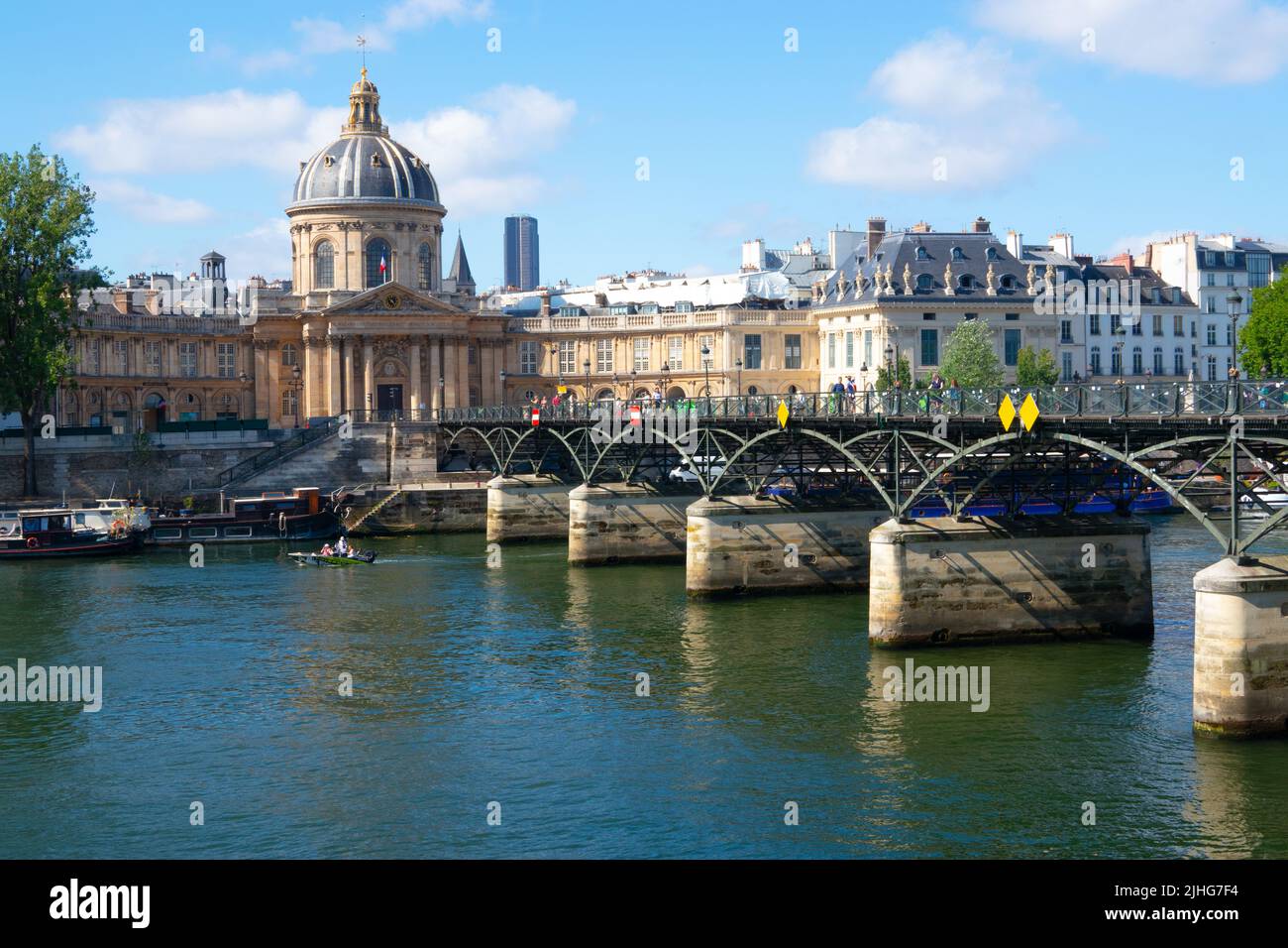 Pont des Arts or Passerelle des Arts pedestrian bridge across River Seine with the dome of Institut de France in the background Paris France Stock Photo