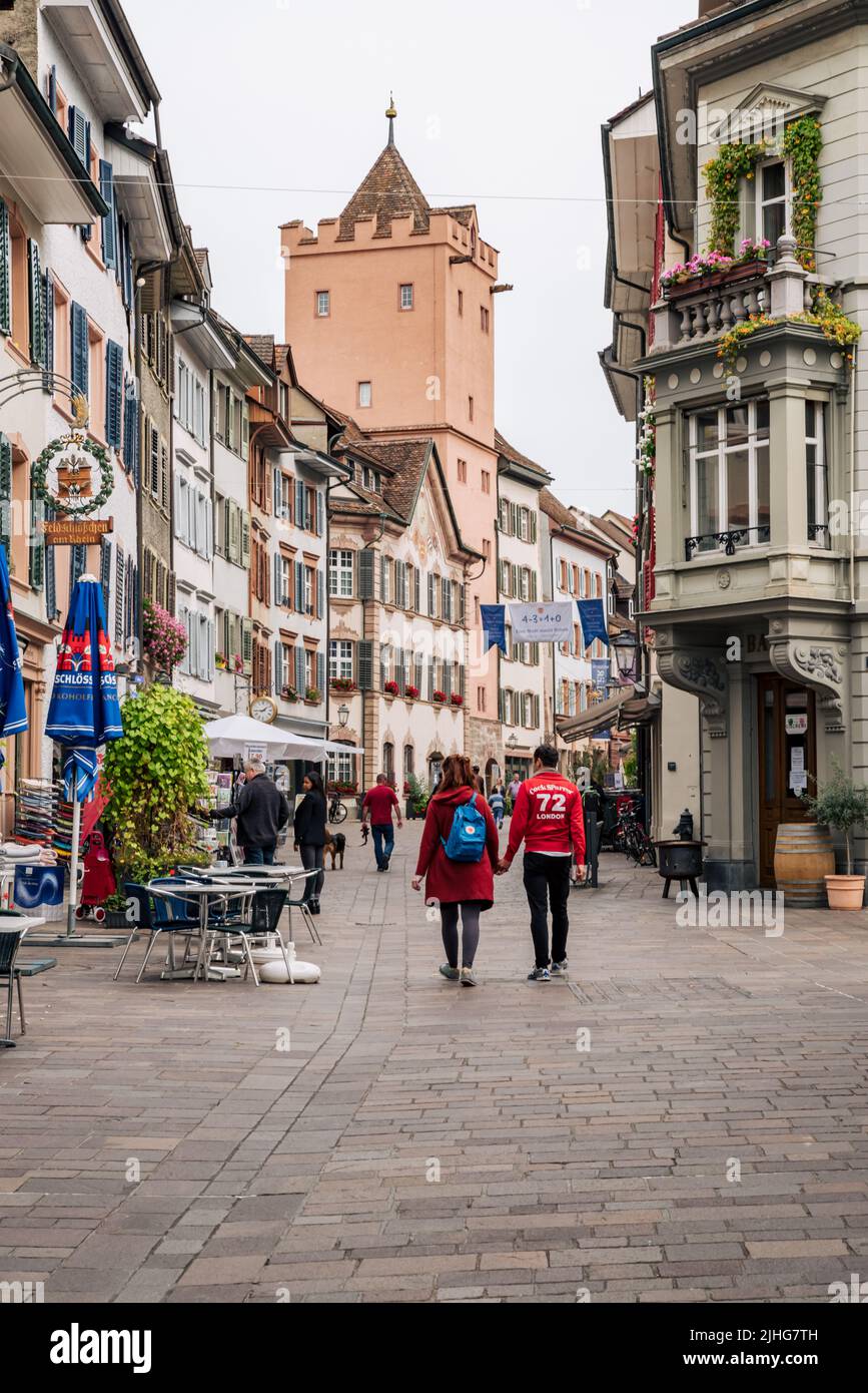 People and tourists walk through the old narrow streets and alleys in Rheinfelden.  Stock Photo