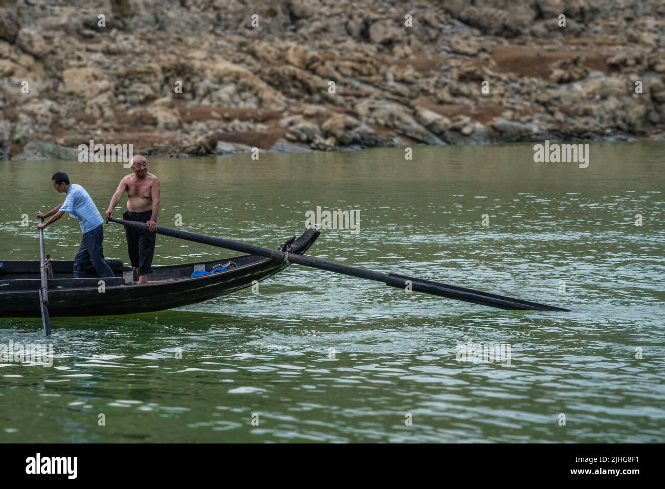 Yangtze River, China - August 2019 : Men catching fish from a small crowded fisherman boats on the Shennong Xi Stream, estuary of the mighty Yangtze r Stock Photo