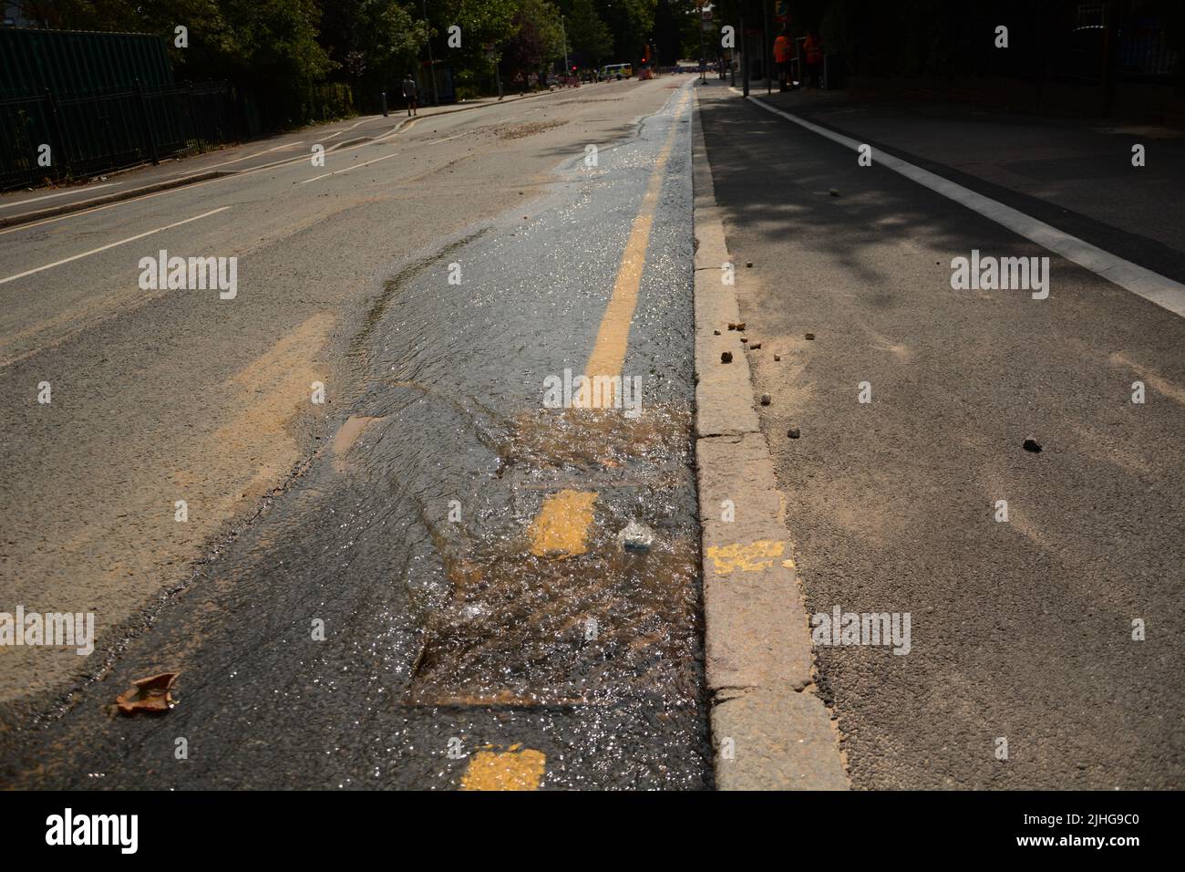 Hot weather causes a major road in Kingston upon Thames to crack and collapse and cause flooding
