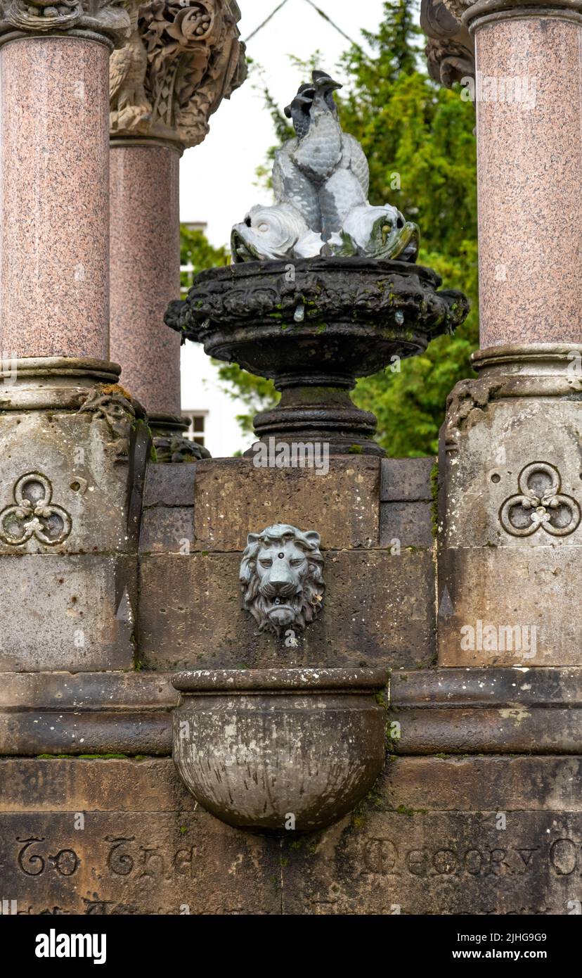 Close and selective focus on a carved stone lion’s head on a stone memorial Stock Photo