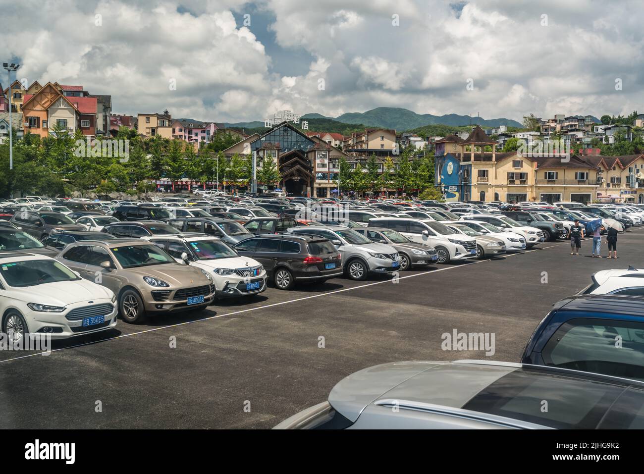Wulong, China - August 2019 : Private cars parked on a big parking lot at the entrance to the museum in Wulong National Park Stock Photo