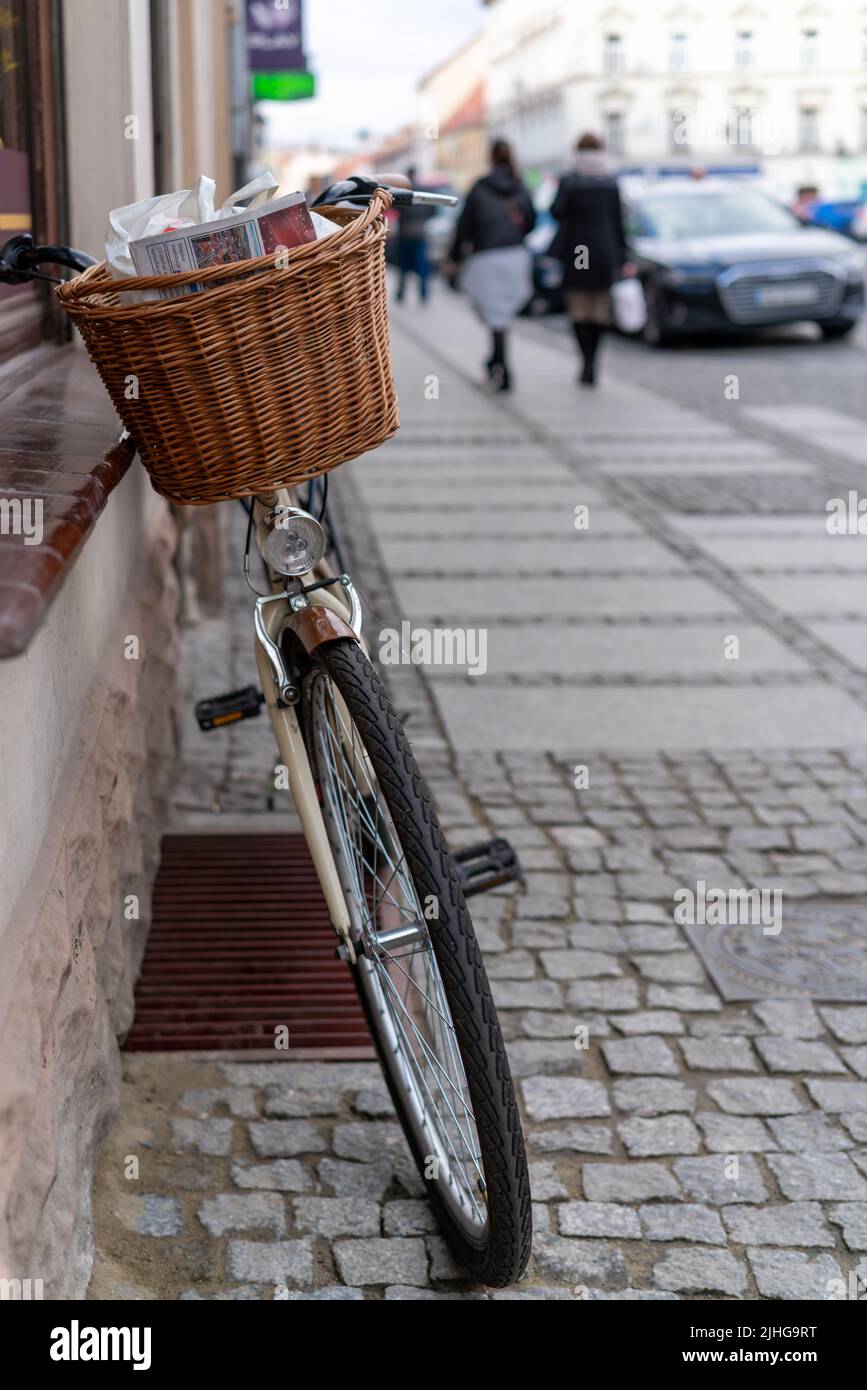 Swiebodziec, Poland - December 2019 : Newspaper in a bicycle basket parked by a old tenemet house wall in Świebodzice, Poland Stock Photo