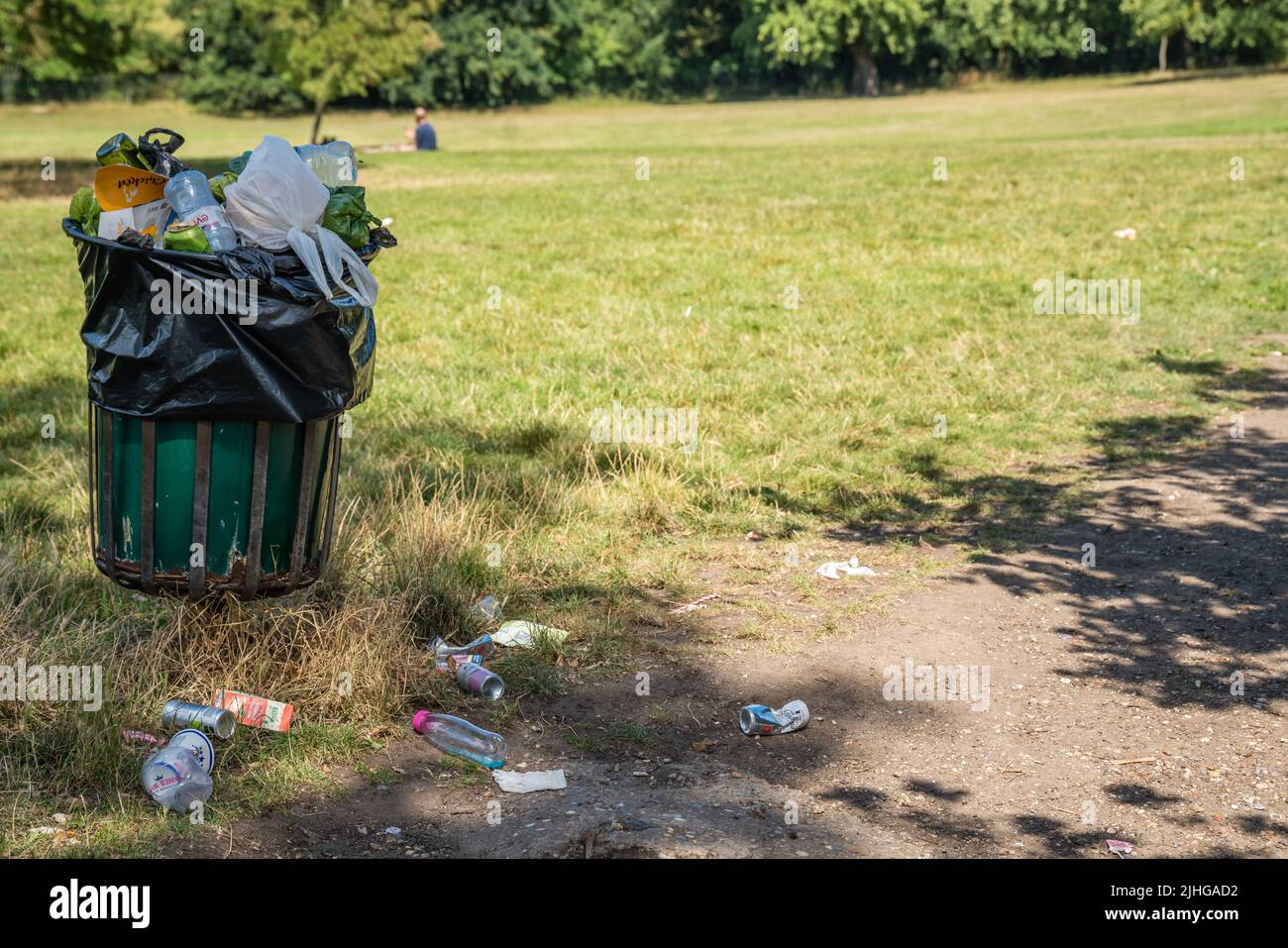 London, UK July 2020 Overflowing large rubbish and litter garbage and waste bin in a nature
