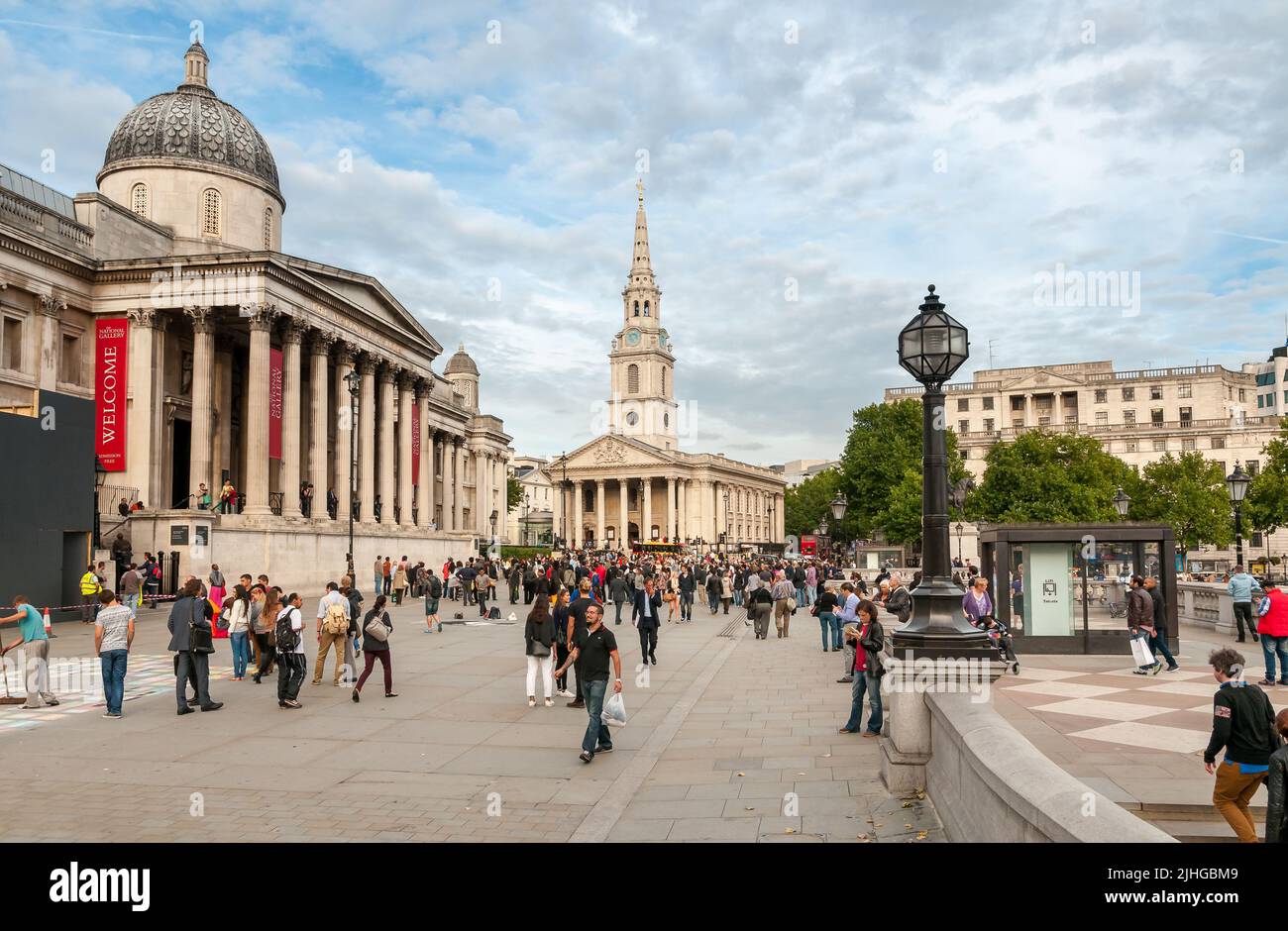 London, England, United Kingdom - September 26, 2013: People visiting the Trafalgar Square with the National Gallery and St Martin in the Fields Churc Stock Photo