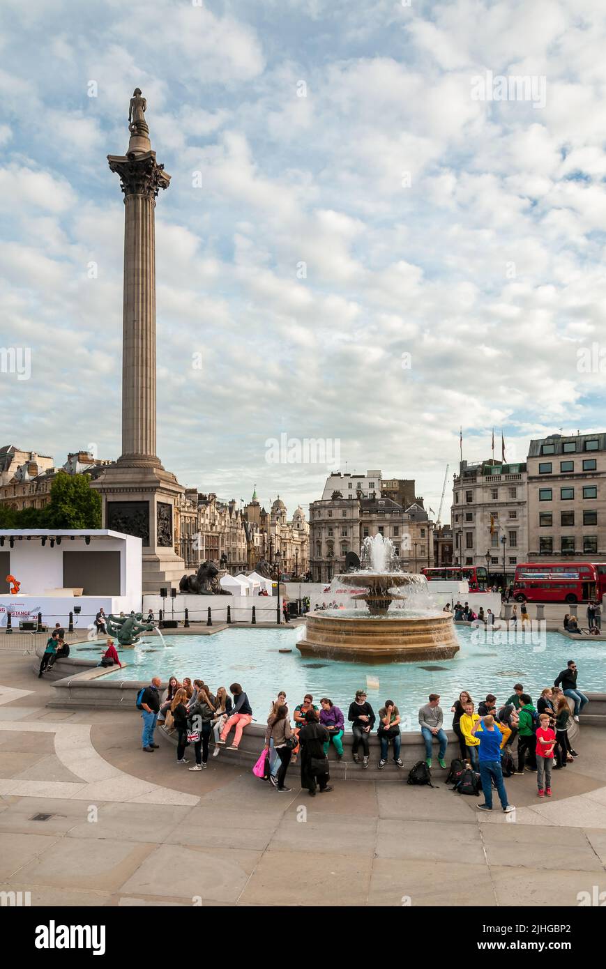 London, England, United Kingdom - September 26, 2013: People resting beside the fountain on the Trafalgar Square in central London. Stock Photo
