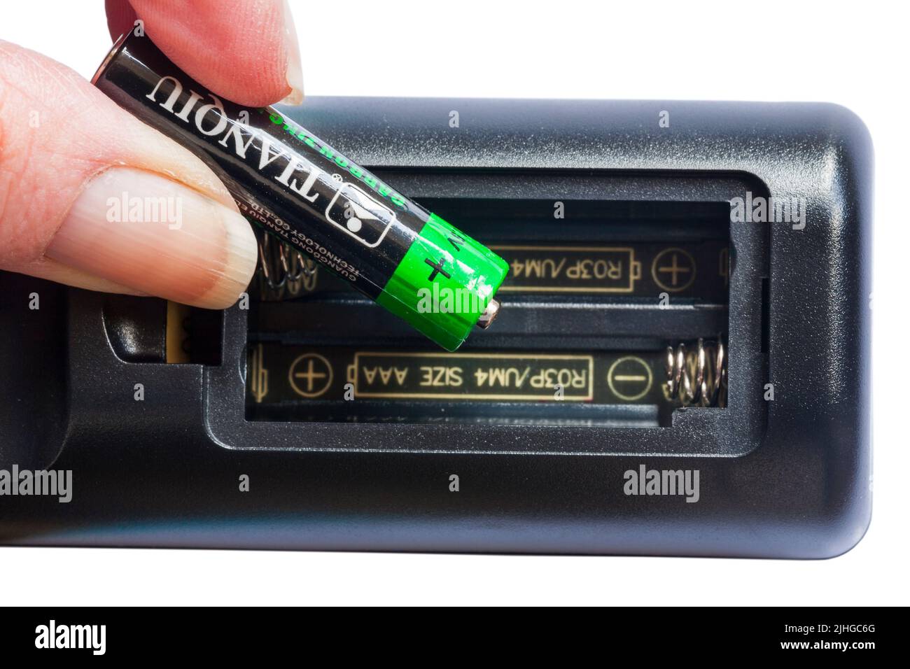 Tianqiu carbon zinc battery woman changing batteries in remote