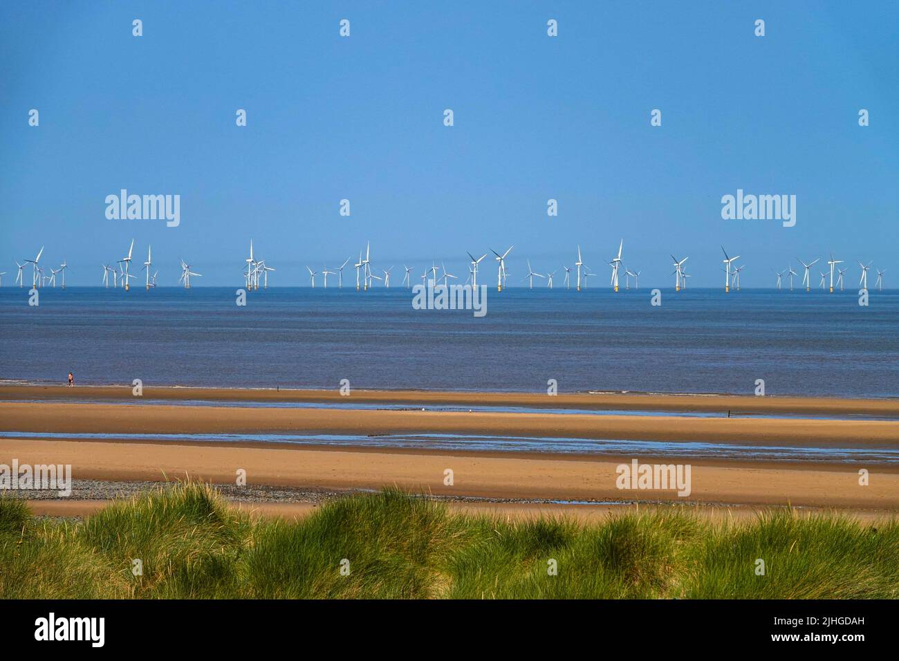 Hottest day ever in the UK at Talacre Beach, and the Point of Ayr lighthouse, Flintshire, North Wales, with Burbo Bank Offshore Wind Farm Stock Photo
