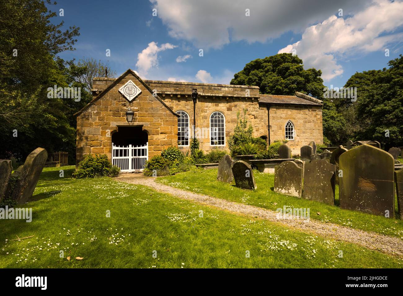 All Saints Church, Great Ayton dating from 12th century built of local sandstone. The church grounds contain the family grave of Captain James Cook. Stock Photo