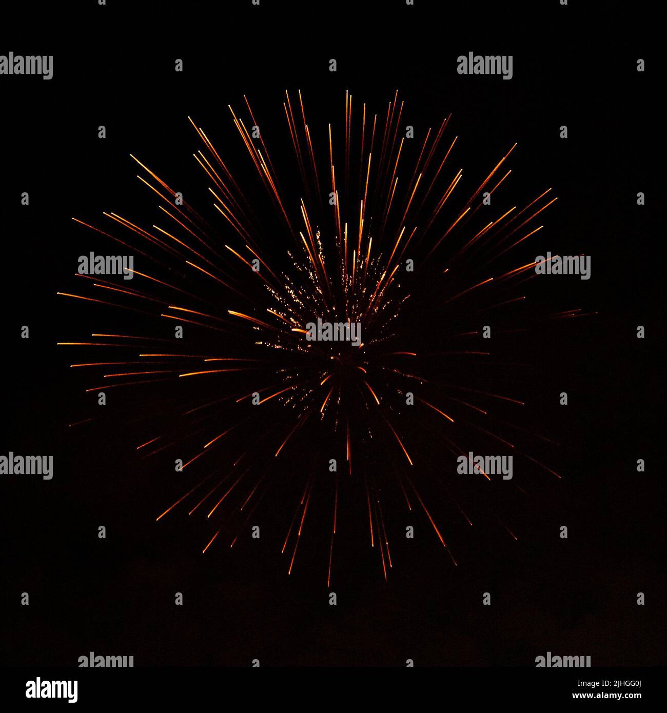 Bright fireworks with a sphere or circle shape exploding against black