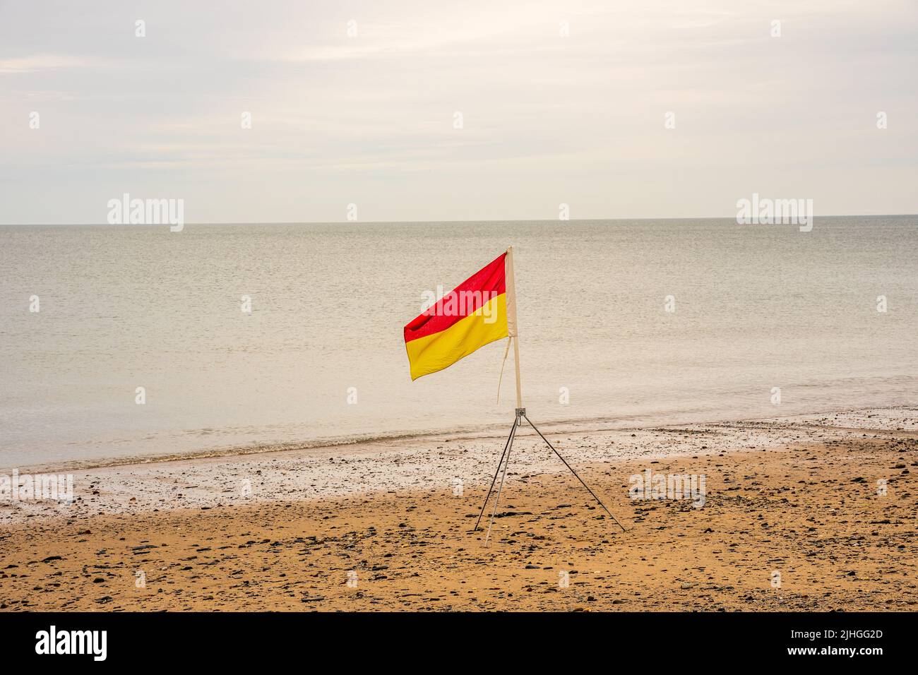 red and yellow danger warning flags on beach life saving guards safety