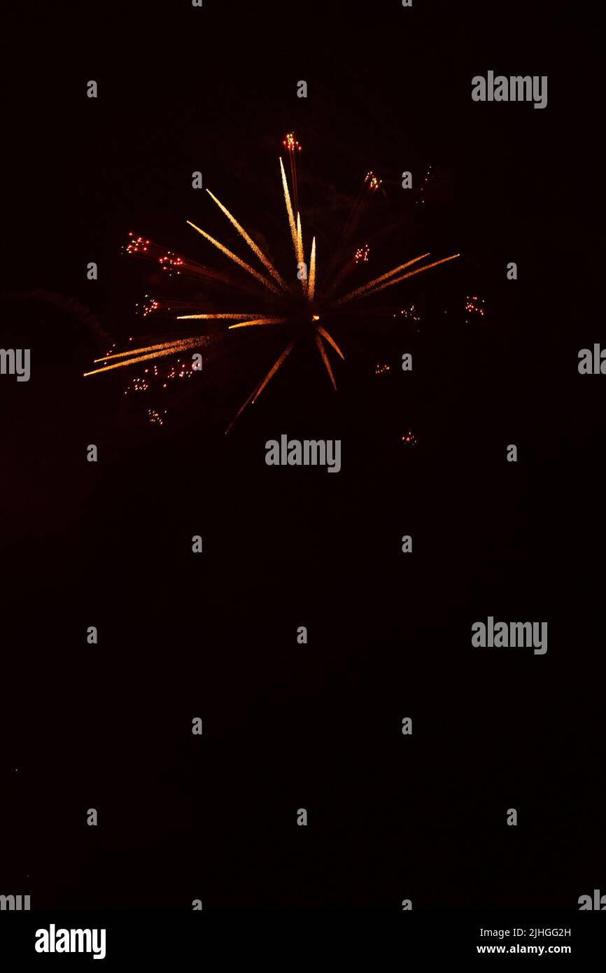 Bright fireworks with a sphere or circle shape exploding against black