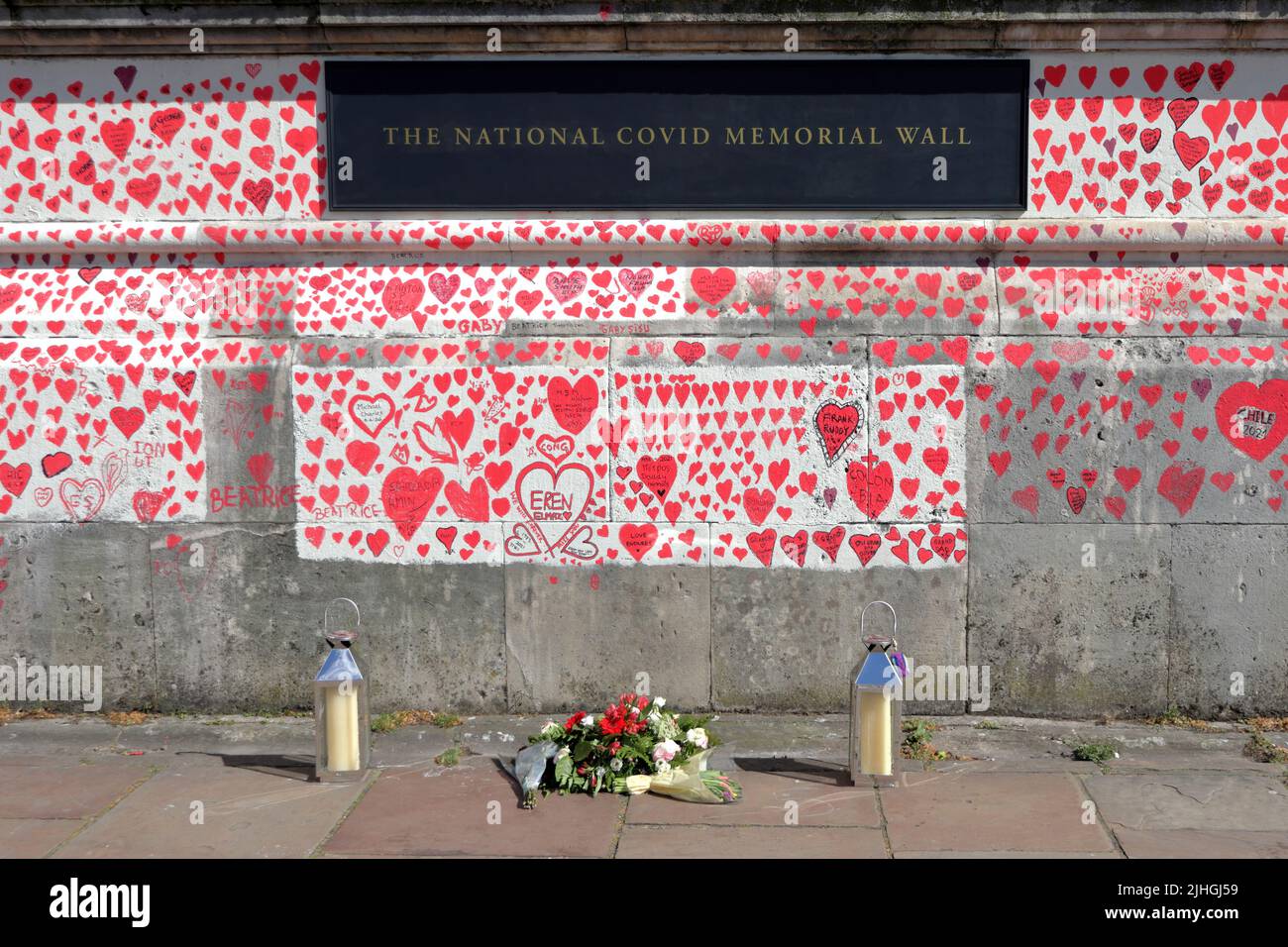 London, UK - March 30, 2021: The National Covid Memorial Wall, volunteers painting 150,000 red hearts to commemorate Covid-19 deaths Stock Photo