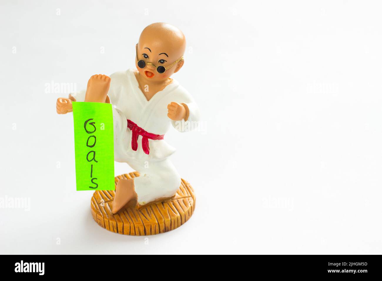 Card hanging on foot karate sportsman "Goals". White background Stock