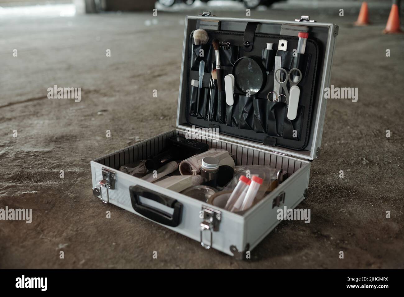 Open briefcase with working supplies of criminological expert or crime