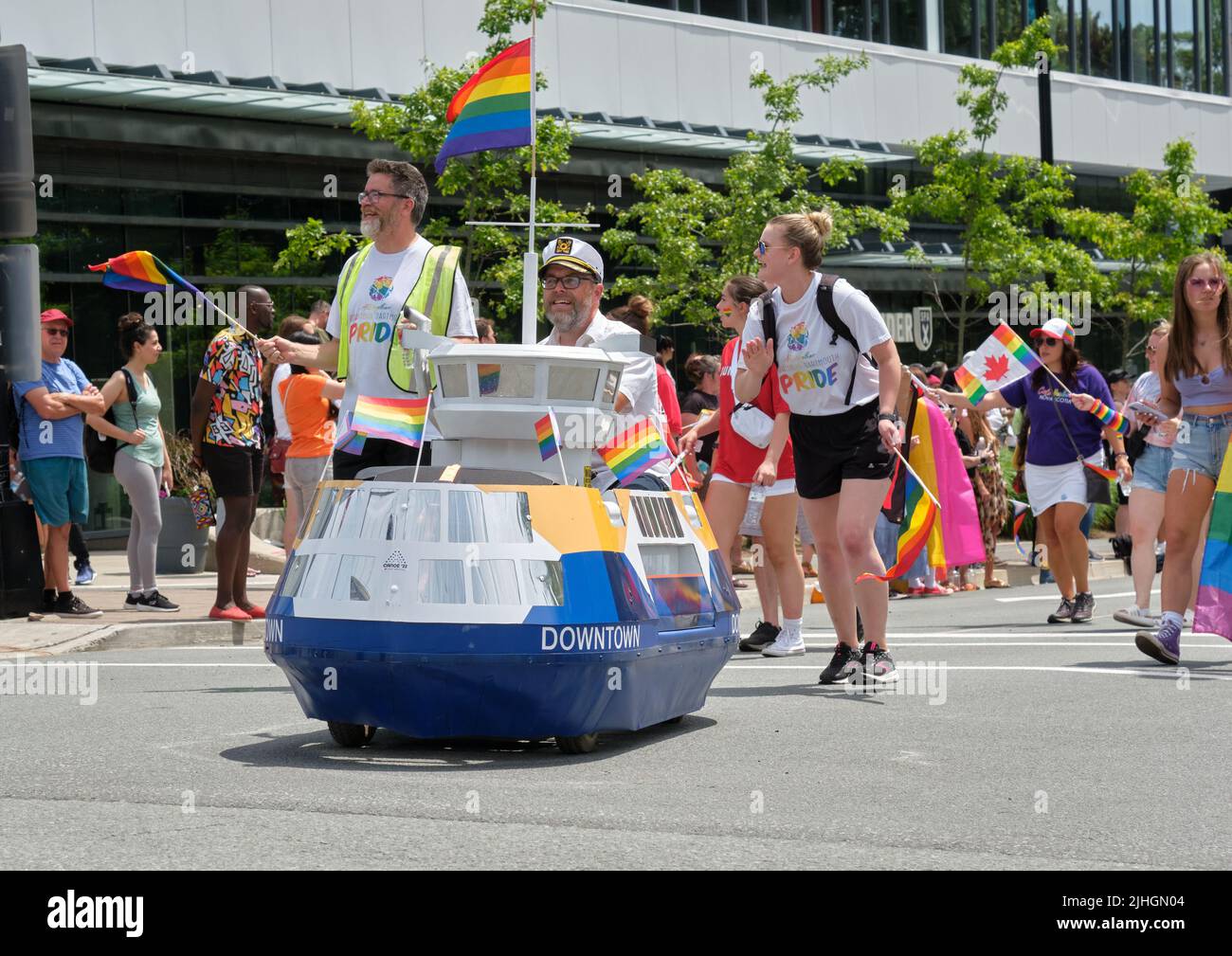 Halifax, Canada. July 16th, 2022. The Halifax Pride Parade through streets of city. Miniature ferry replica in pride colours leading way Stock Photo