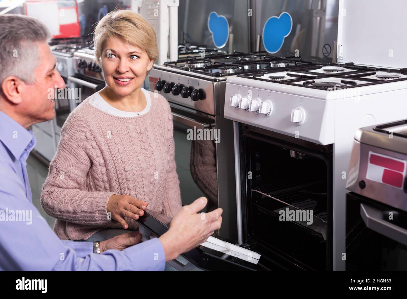 Wife and husband are buying in center of household appliances the plate Stock Photo