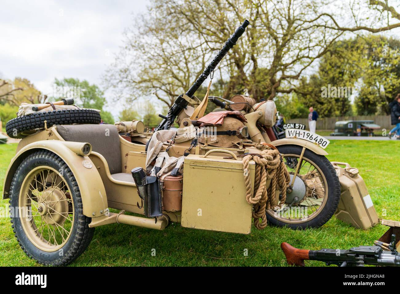 World war two vintage German motorcycle and side car with mounted MG34 machine gun. Painted yellow-green for afrika korps desert camouflage. Stock Photo