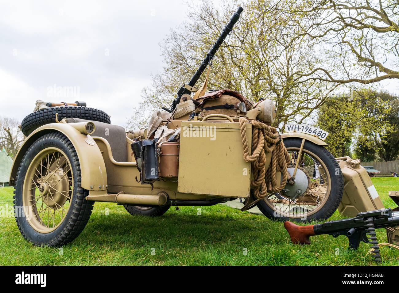World war two vintage German motorcycle and side car with mounted MG34 machine gun. Painted yellow-green for afrika korps desert camouflage. Stock Photo