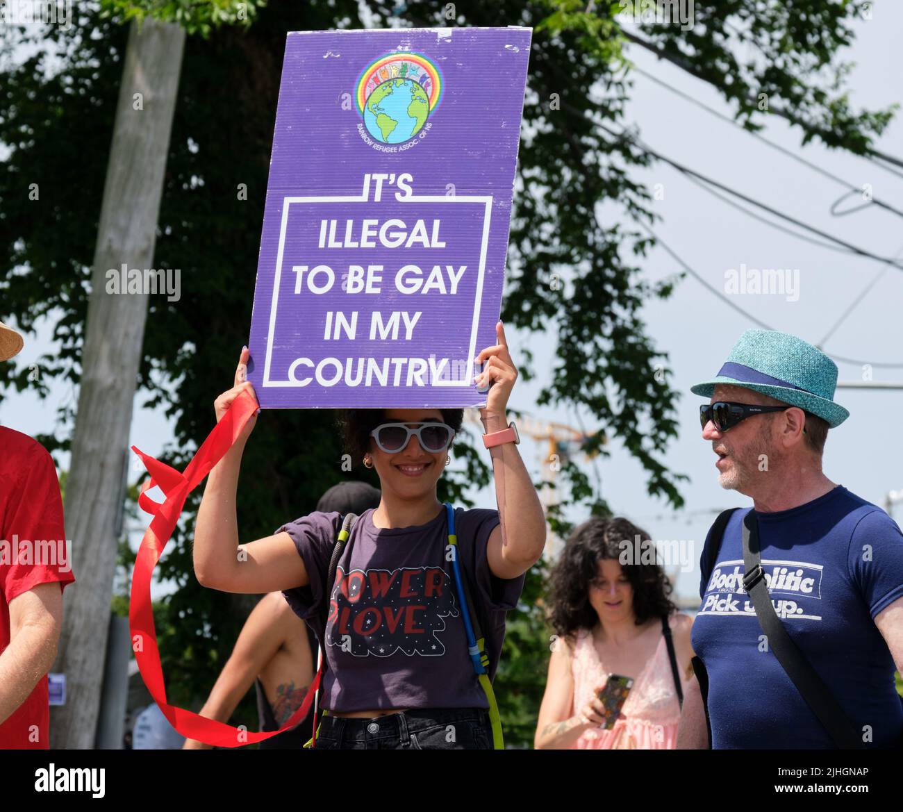 Halifax Pride Parade- Participant with sign 'It's Illegal to be Gay in my Country ' (unidentified country) Stock Photo
