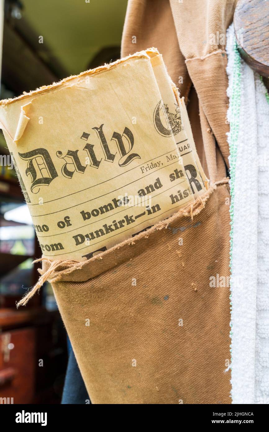 Close up of a folder newspaper sticking out of the top of a canvas pocket, dated May 1940 with headline concerning Dunkirk Stock Photo