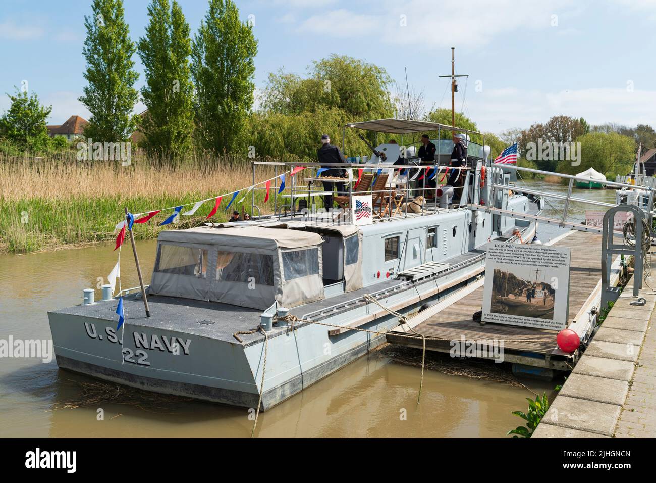 1950's US Navy patrol boat P22 moored at a pontoon and draped in flags during a event at Sandwich in Kent. Before it was a Rhine River patrol boat. Stock Photo