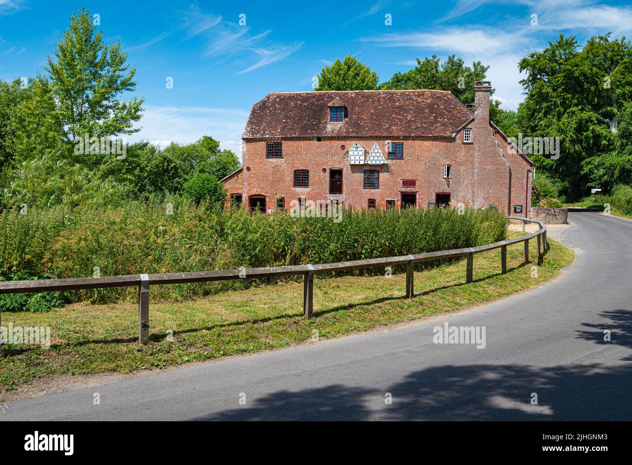White Mill a 18th century corn mill powered by the river stour with nature and wildlife on the grounds with birght sunshine and blue sky. Stock Photo